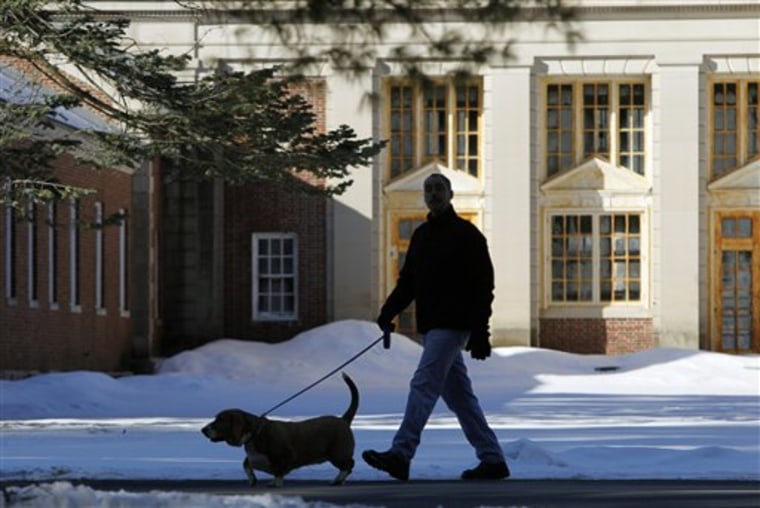 A man walks a dog at Saratoga Spa State Park in Saratoga Springs, N.Y., on Friday. New York's state parks system is facing another round of funding cuts that could result in the first budget-related closures in the system's 125-year history.